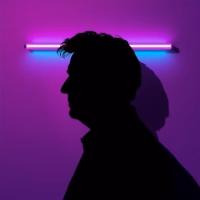 Silhouette of Devon Miles at his desk